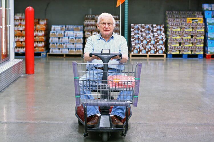 Older gentleman cruising around the supermarket on a mobility scooter