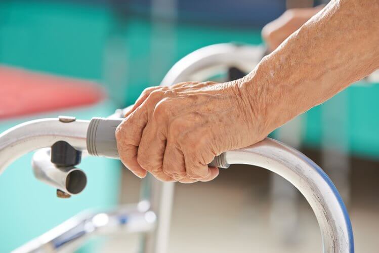 Older person using a walker in a bathroom