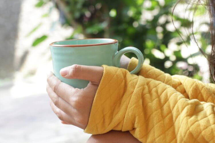 Holding a cup of tea
