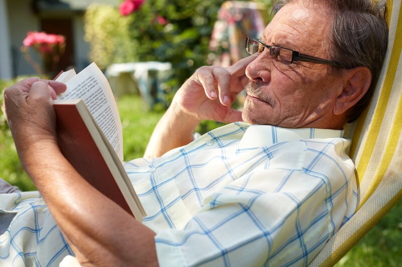 Gentleman reading outdoors