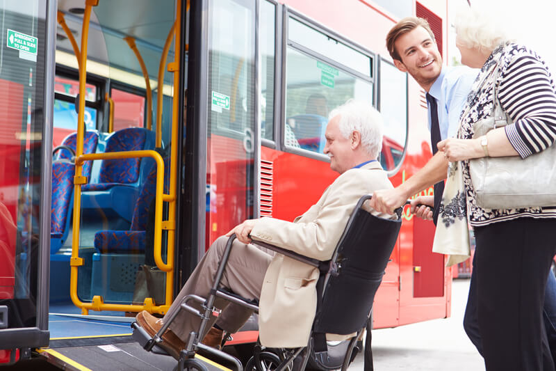 Older person being helped onto a bus