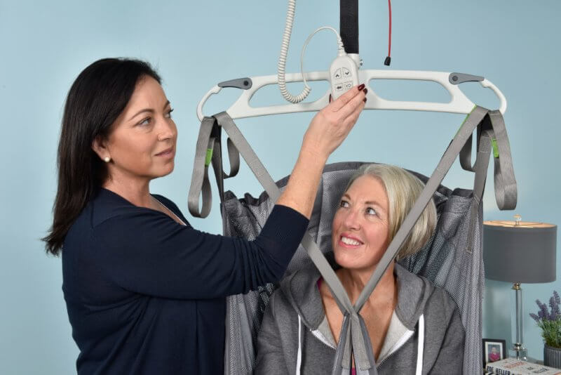 Carer Helping Patient in Sling