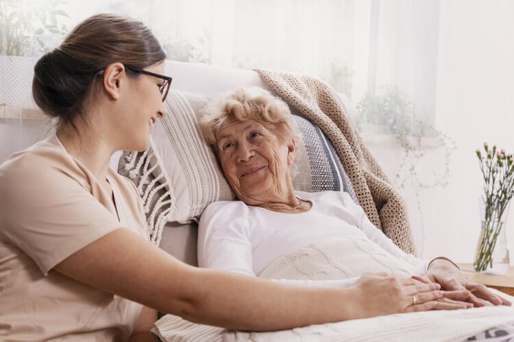 Older woman smiling at her support worker